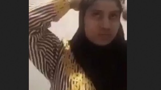 A young woman from India in a hijab plays coyly and displays herself