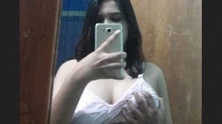 A stunning and attractive young woman displays her large breasts with the approval of her friend's spouse