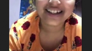 A girl with large breasts proudly displays her full figure