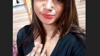 An attractive young woman from South Asia reveals her breasts and intimate area