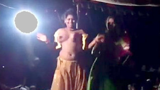 Sensual Indian dance performance in open-air village setting