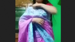 A stunning Indian woman removes her traditional sari and displays herself