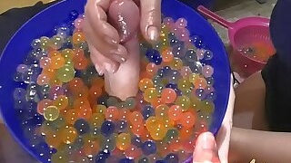 Young girl makes soft hanjob with lots of oil and water balls
