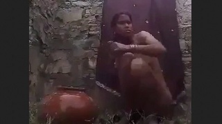 Village wife relaxes in open-air bath