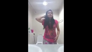 A young Indian woman showcases her curves and self-pleasure in a solo video captured on her mobile device