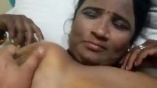 A mature woman from Tamil, India engages in sexual activity