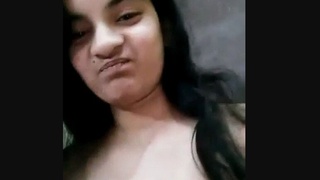 A charming brunette woman confidently showcases her attractive physique in an enticing manner