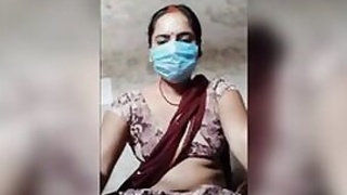 Desi XXX face masked wife shows her tits and pussy on live camera