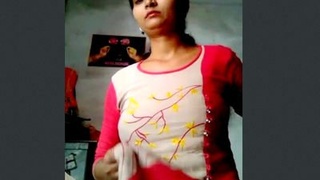 A seductive Indian woman of Desi origin displays her breasts and intimate area.