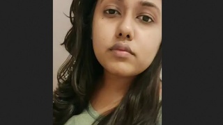 A charming Indian girlfriend takes a selfie while in bed