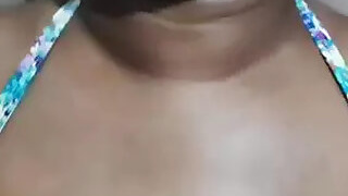 A teacher from Sri Lanka bathes in a sari and...