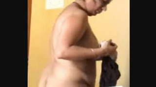 Indian aunt undresses in front of camera