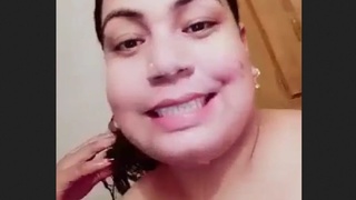 Indian woman takes bath and works with milk in tanker