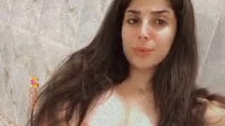A stunning Pakistani beauty with large breasts and a revealing pussy performs