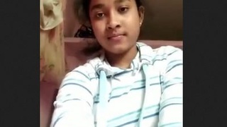 A charming South Asian woman displays her breasts and vagina in a video