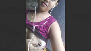 A lovely girl indulging in self-pleasure with her breasts