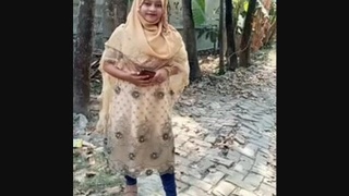 A charming Bengali woman entices and displays her attractive physique, including her intimate area.